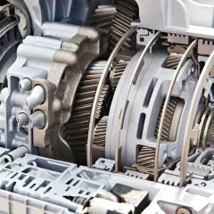 Przekrój nowoczesnej skrzyni biegów, ukazujący złożone elementy mechaniczne, takie jak koła zębate i sprzęgła, kluczowe dla jej działania.